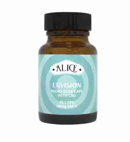 A premium bottle of Envision Alice Micro Dose Capsules neatly arranged next to scattered vegan caps on a clean wood surface.