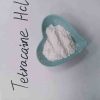 A sealed, pharmaceutical-grade container of high-purity Tetracaine Hydrochloride crystalline powder on a sterile laboratory workstation.